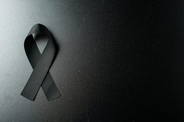 top-view-black-bow-as-mourning-symbol-dark-wall